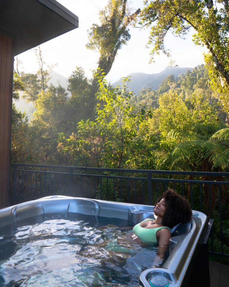 Women Soaking In Hot Tub In Rainforest Franz Josef Glacier Accommodation